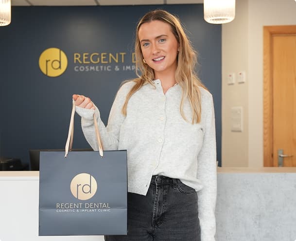 Patient holding a Regent Dental bag at Regent Dental