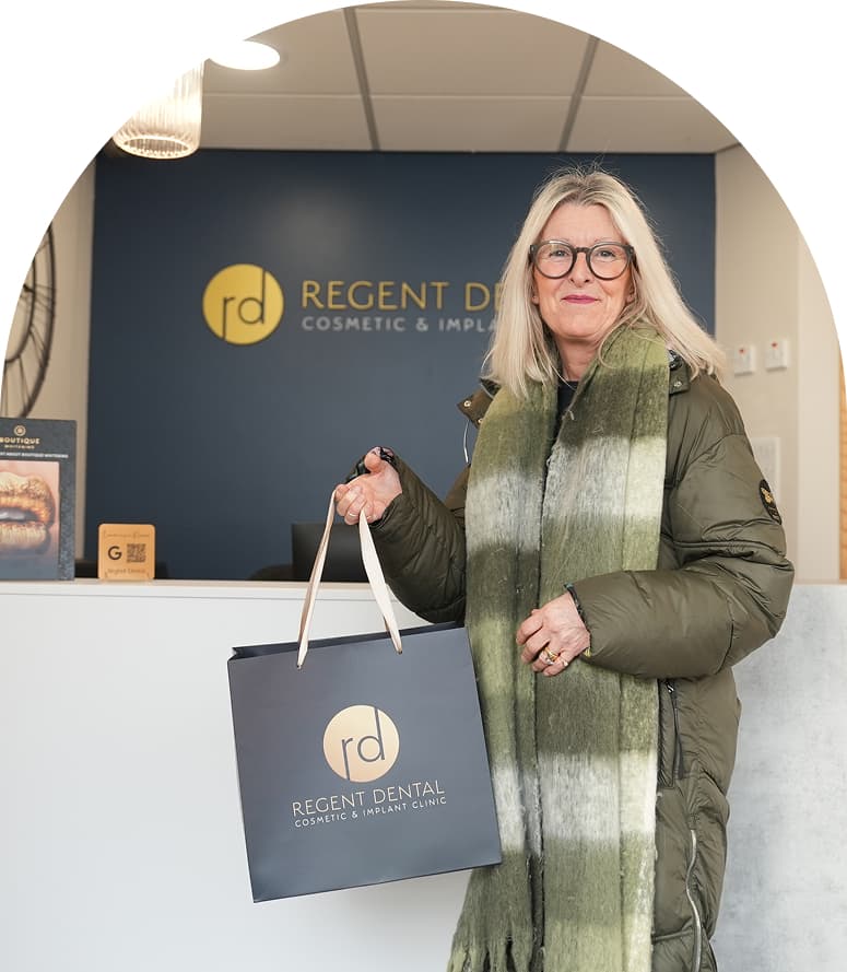 Patient holding a Regent Dental bag at the practice reception