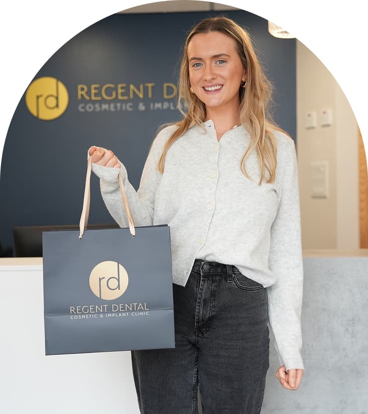 Person holding a Regent Dental bag at the practice reception