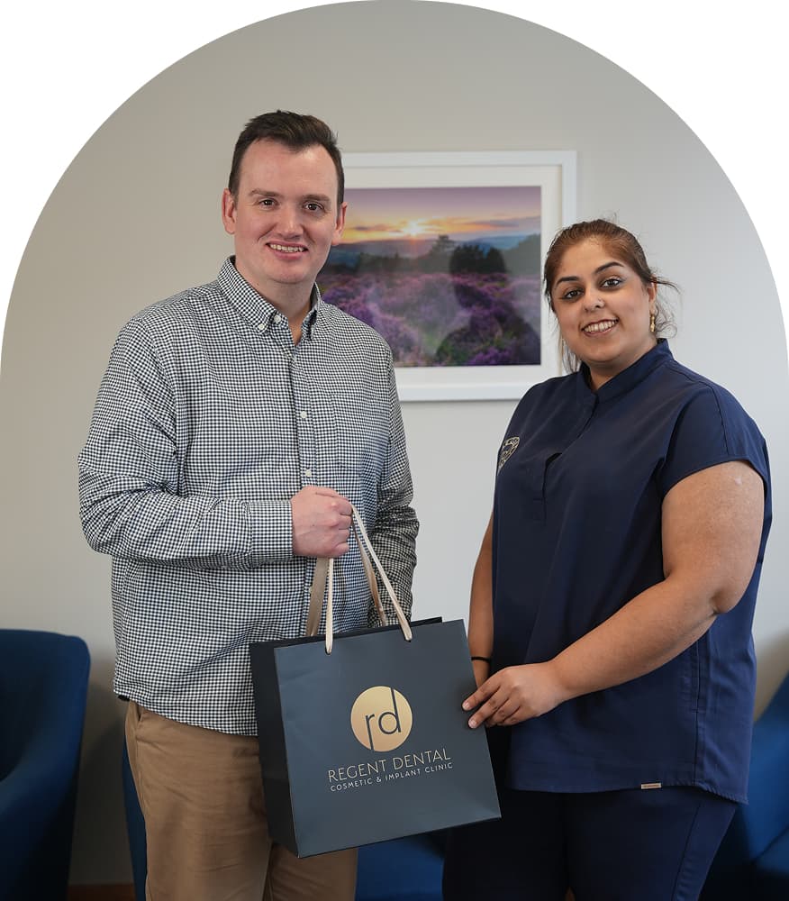 Patient with a Regent Dental team member holding a Regent Dental bag