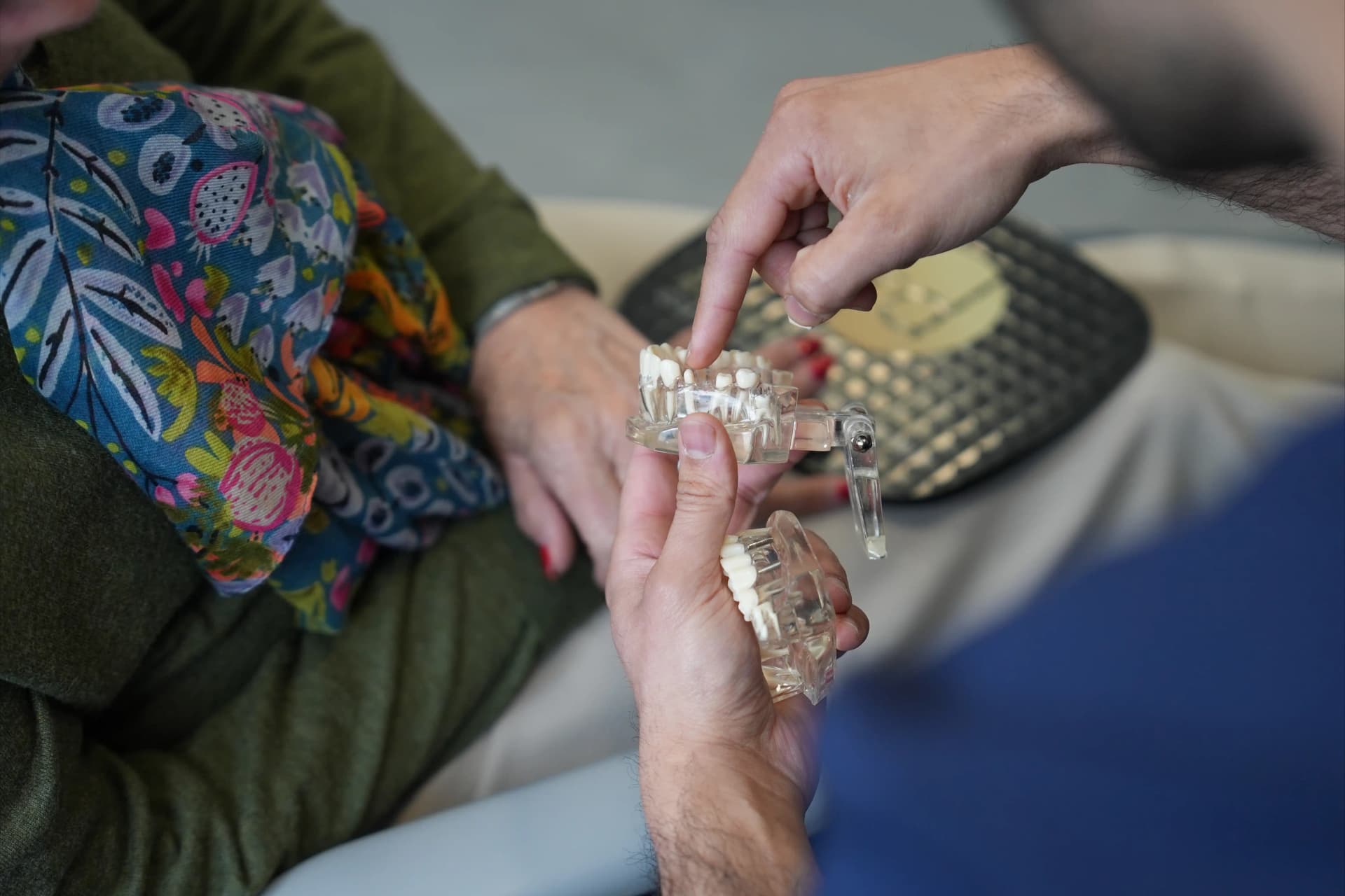 Dental implant model being used to explain treatment options