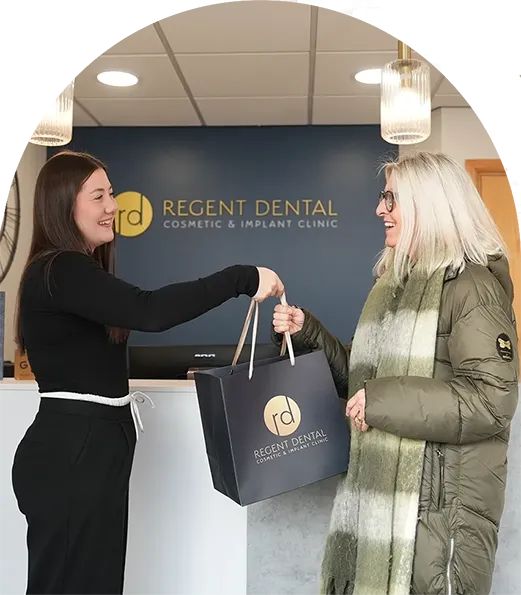 patient at Regent Dental Care holding branded bag